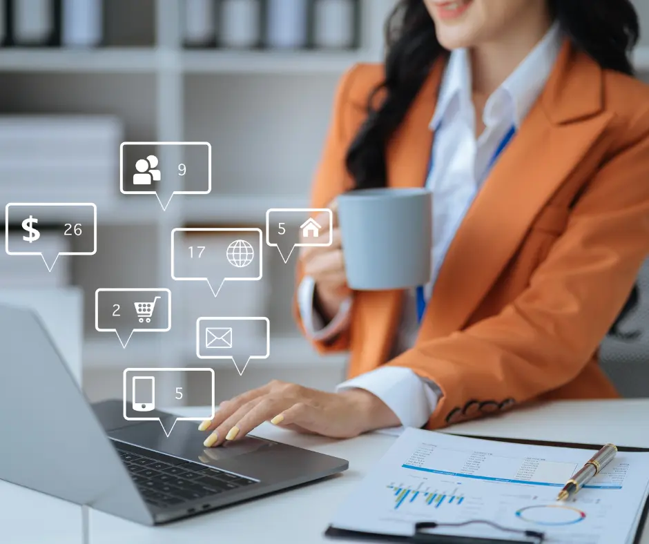 Woman holding cup of coffee and using laptop. 